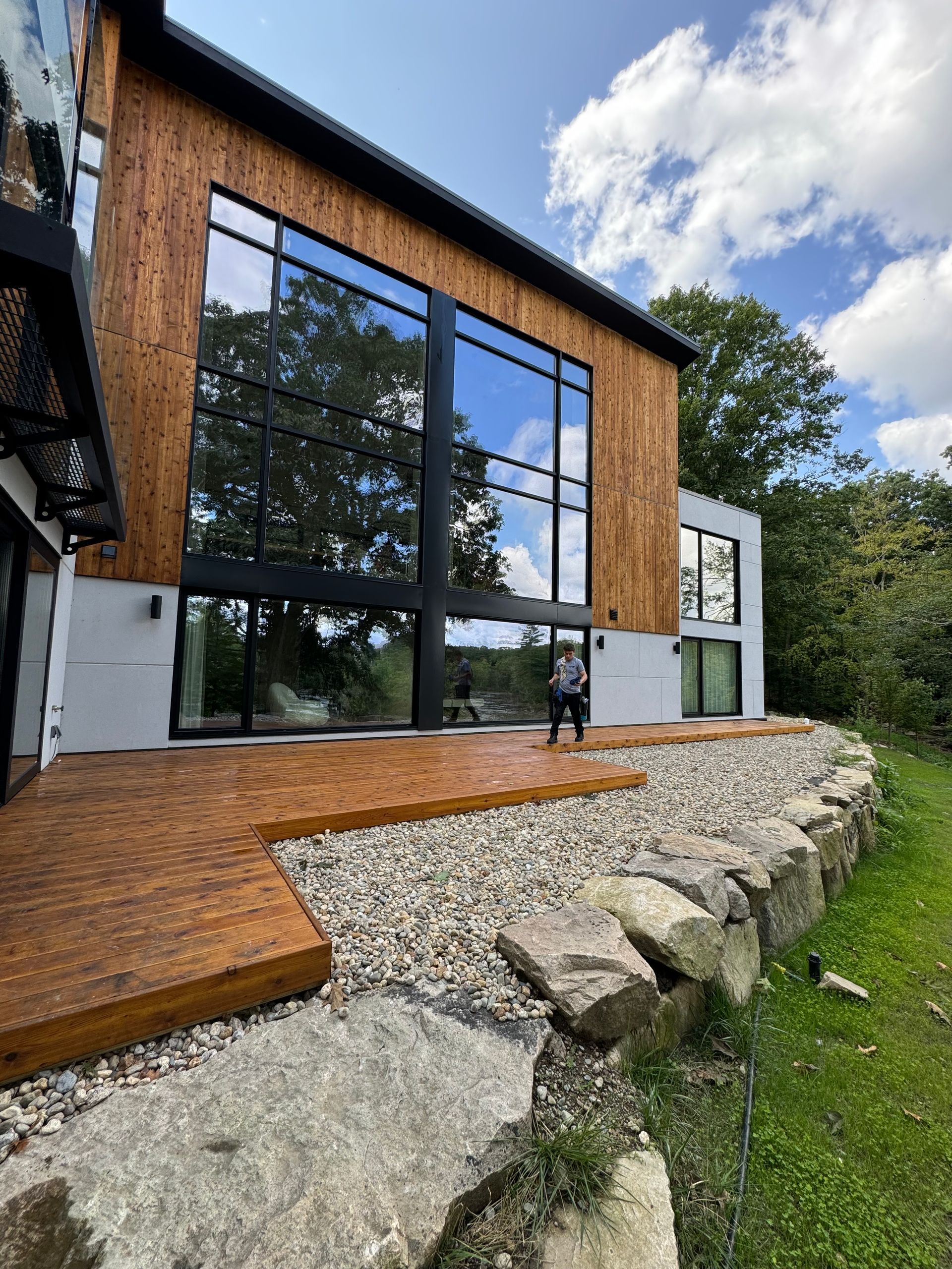 A large house with a lot of windows and a wooden deck.