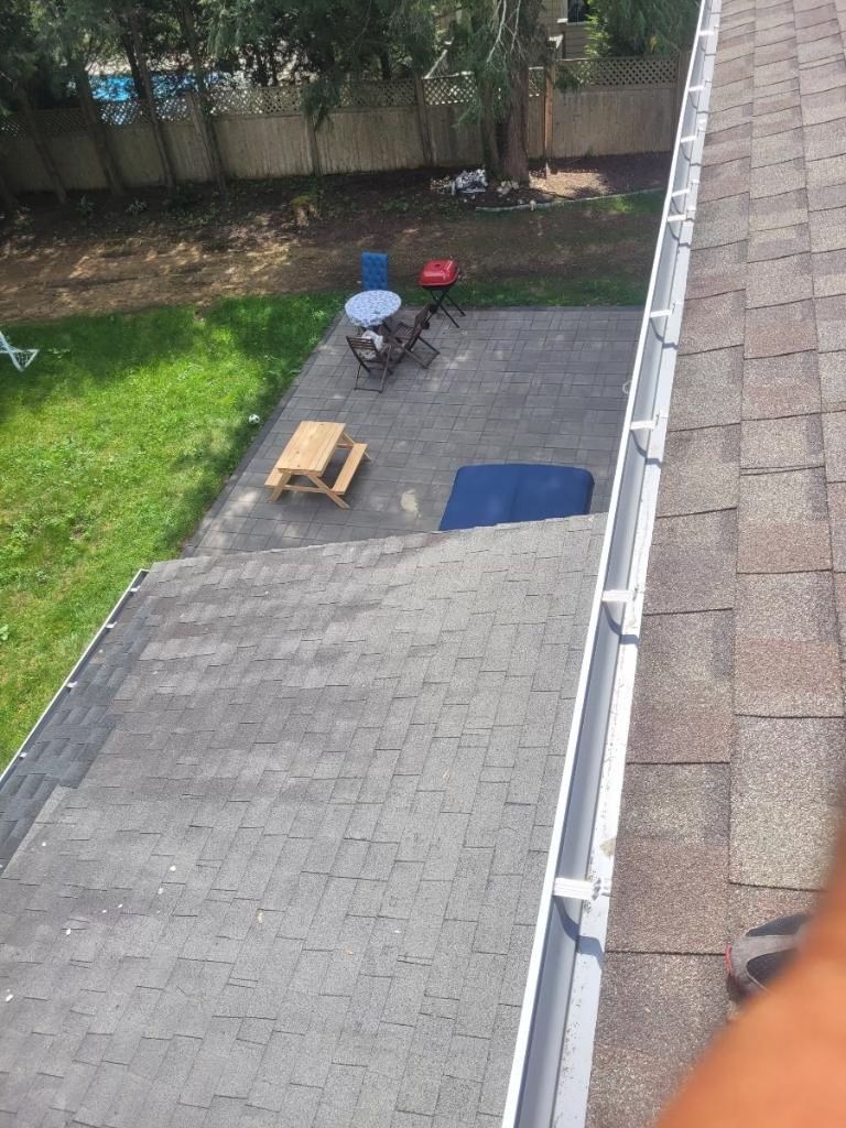 An aerial view of a backyard with a picnic table and chairs.