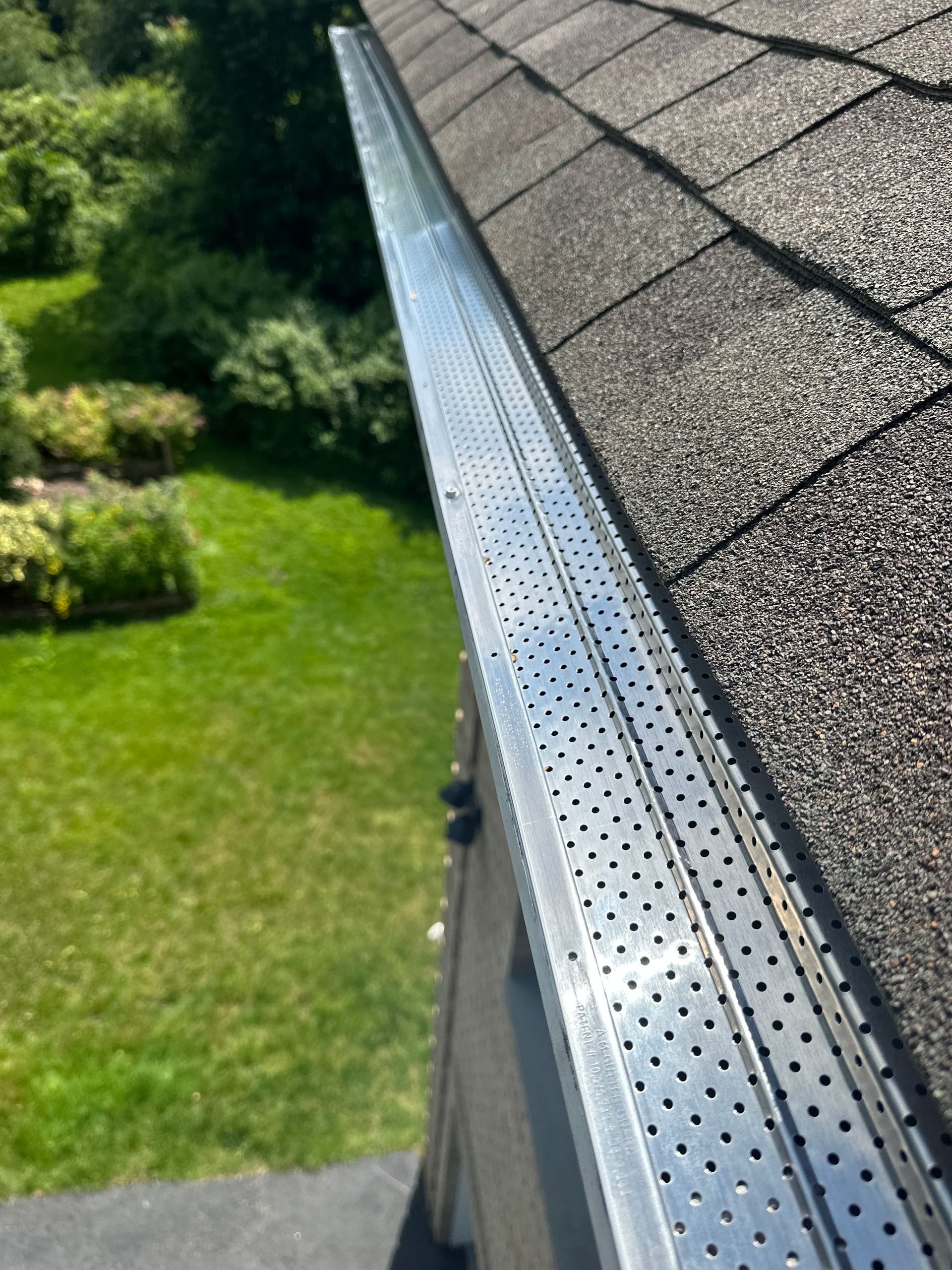 A close up of a gutter on the roof of a house.