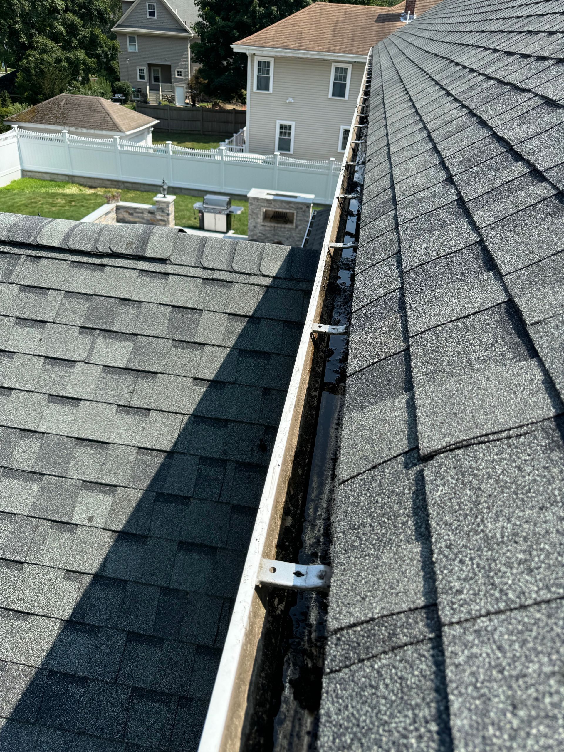 A gutter is attached to the roof of a house.