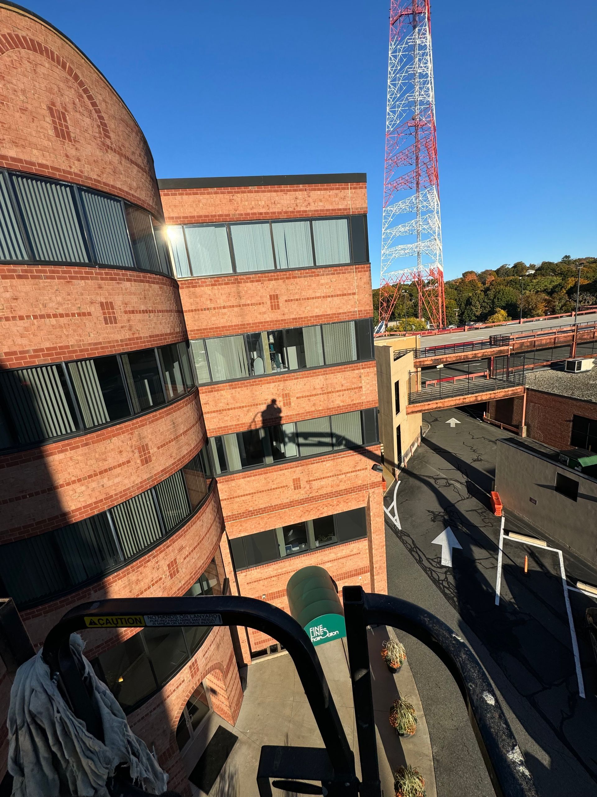 A brick building with a telephone tower in the background.