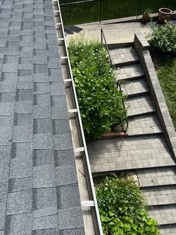 A roof with a gutter and stairs leading up to it.