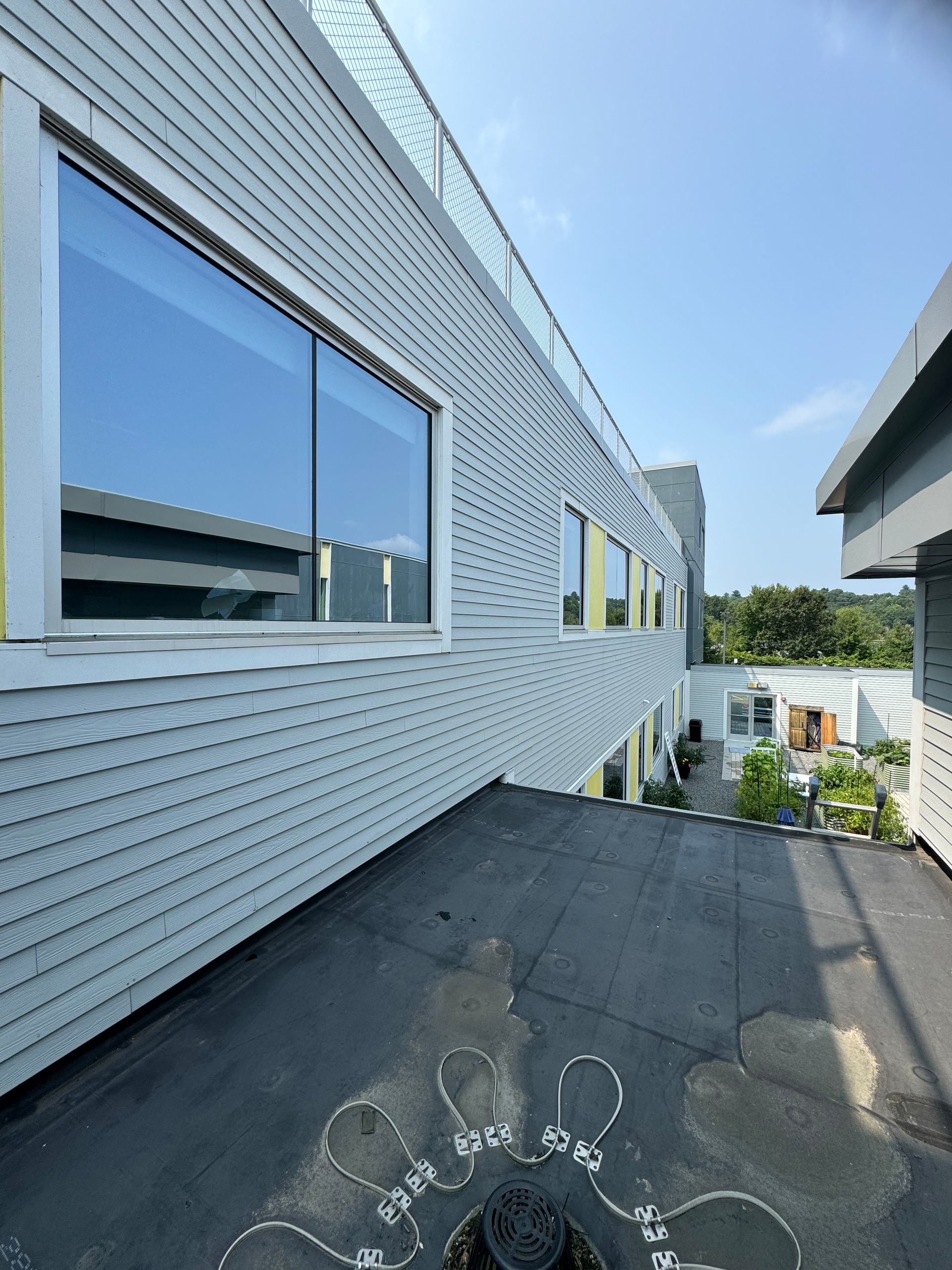 A building with a lot of windows and a black roof.