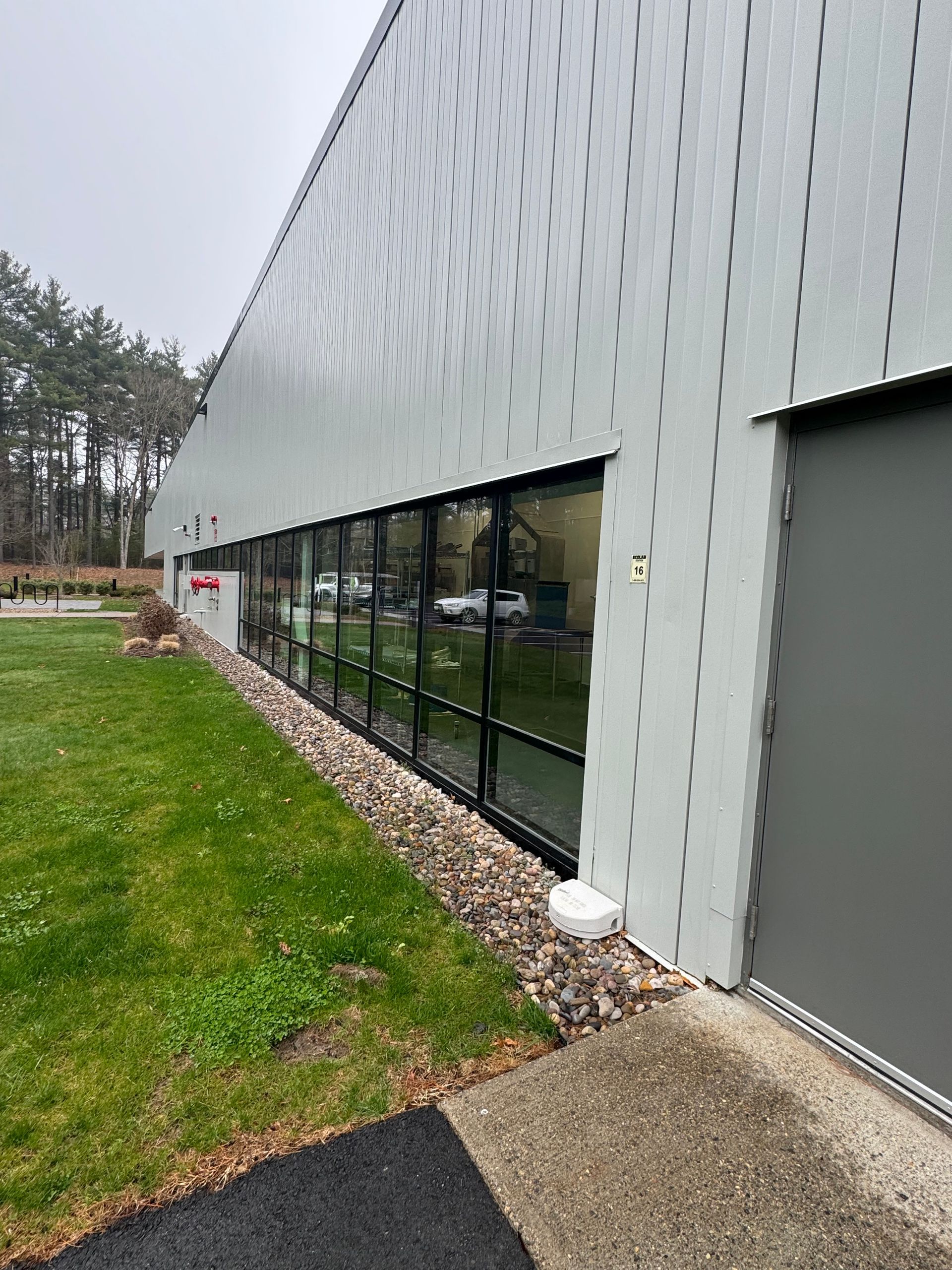 A large building with a lot of windows and a lot of grass.