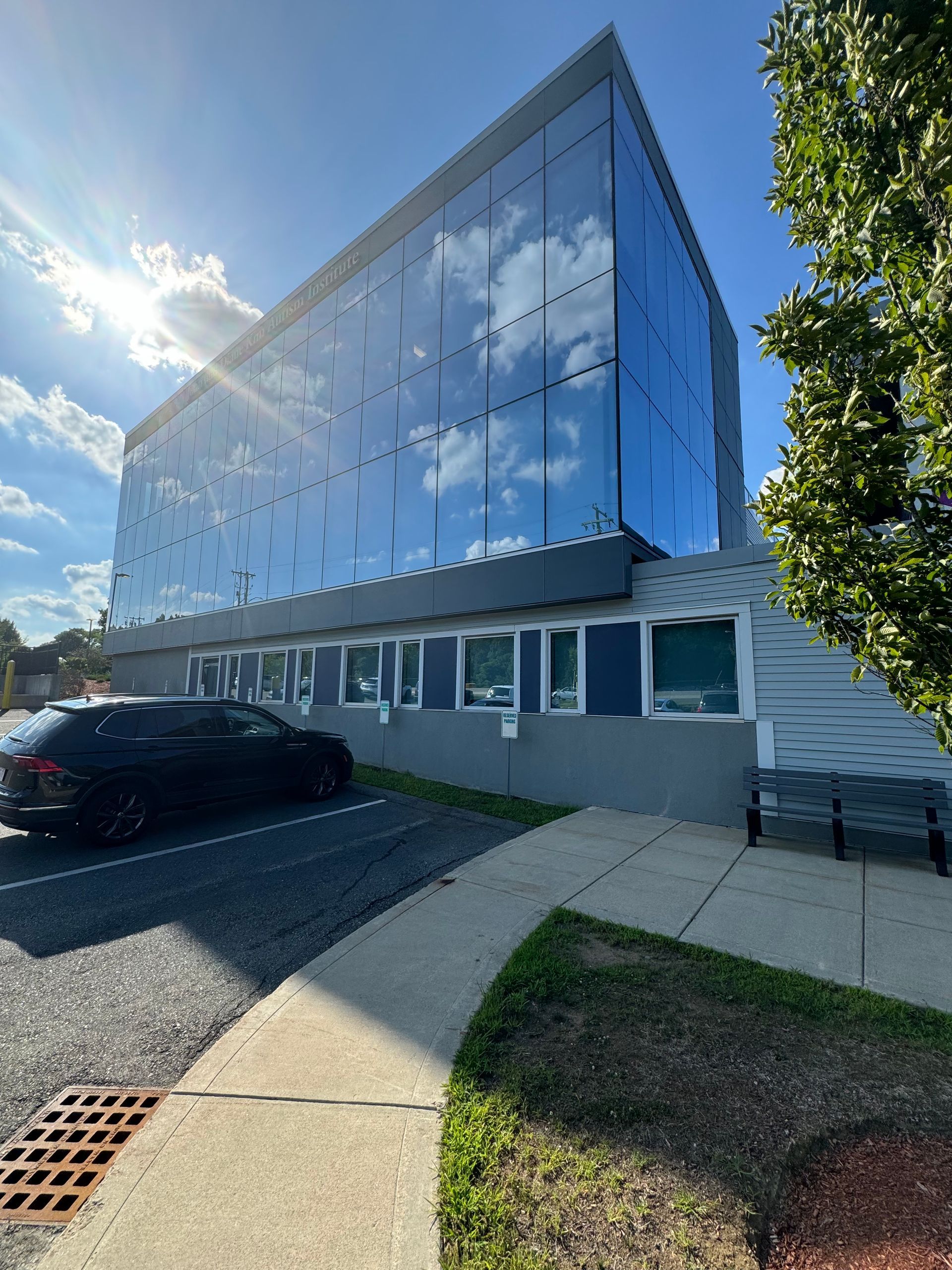 A large building with a lot of windows and a car parked in front of it.