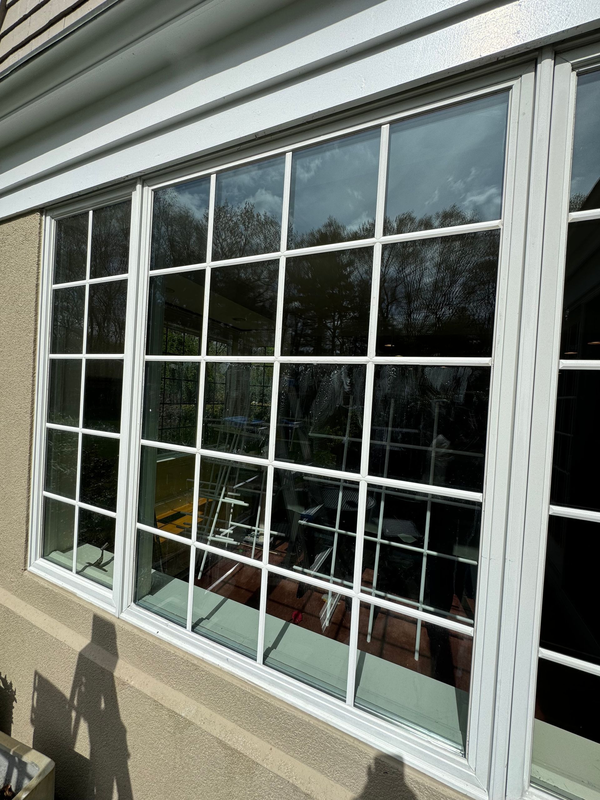 A large window on the side of a house with a lot of windows.