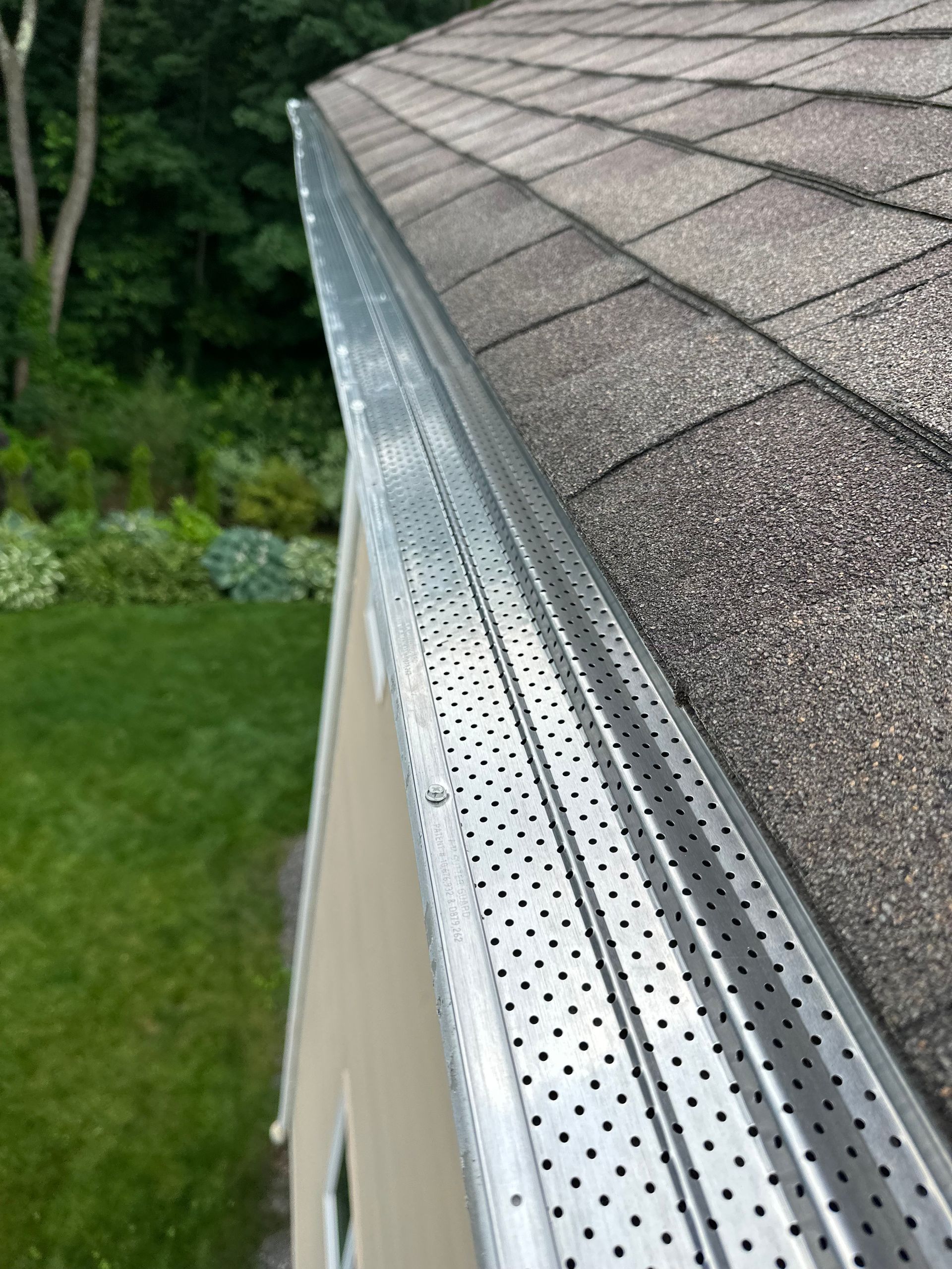 A close up of a gutter on a roof of a house.