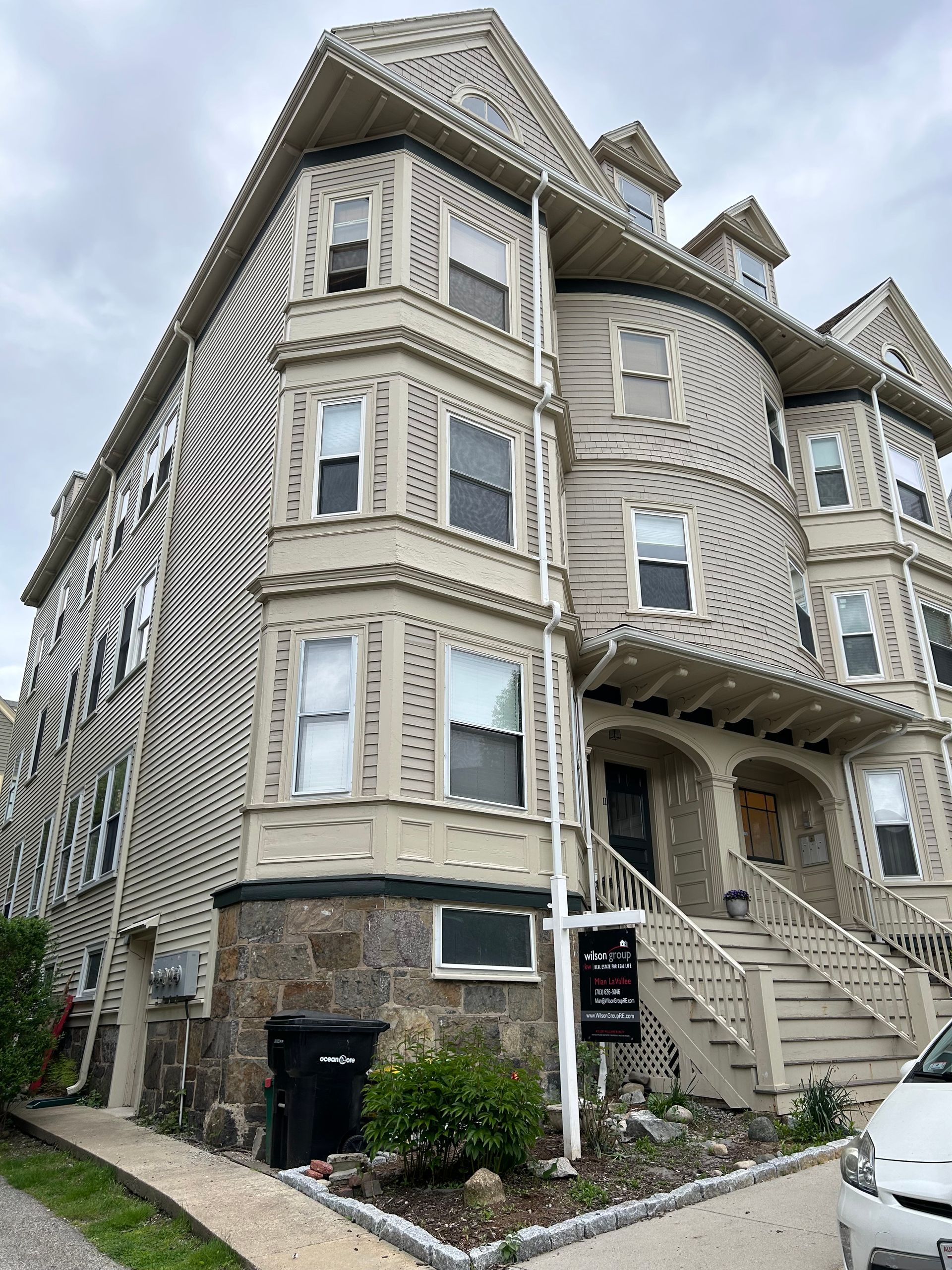 A large building with a lot of windows and stairs is for sale.