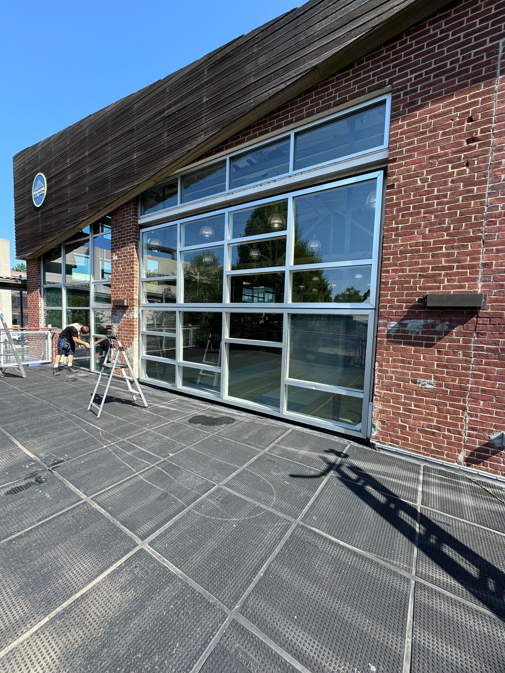 A brick building with a lot of windows and a patio in front of it.