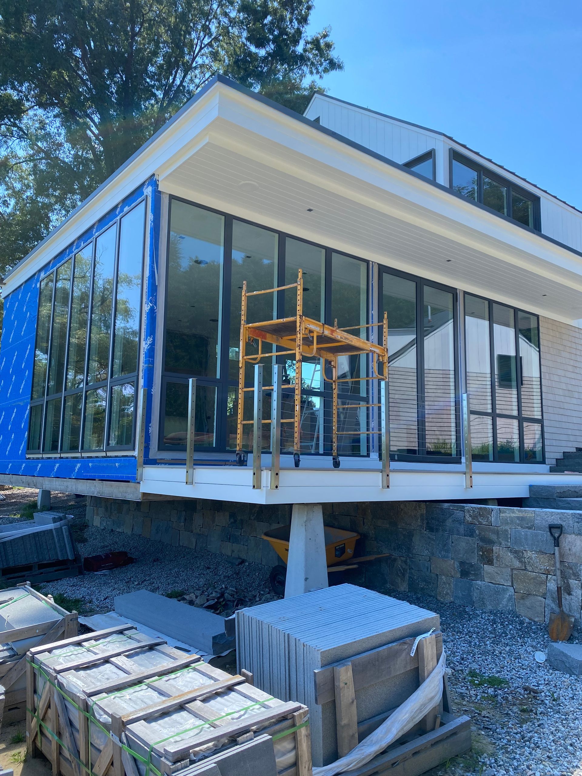 A house with a lot of windows is being built.