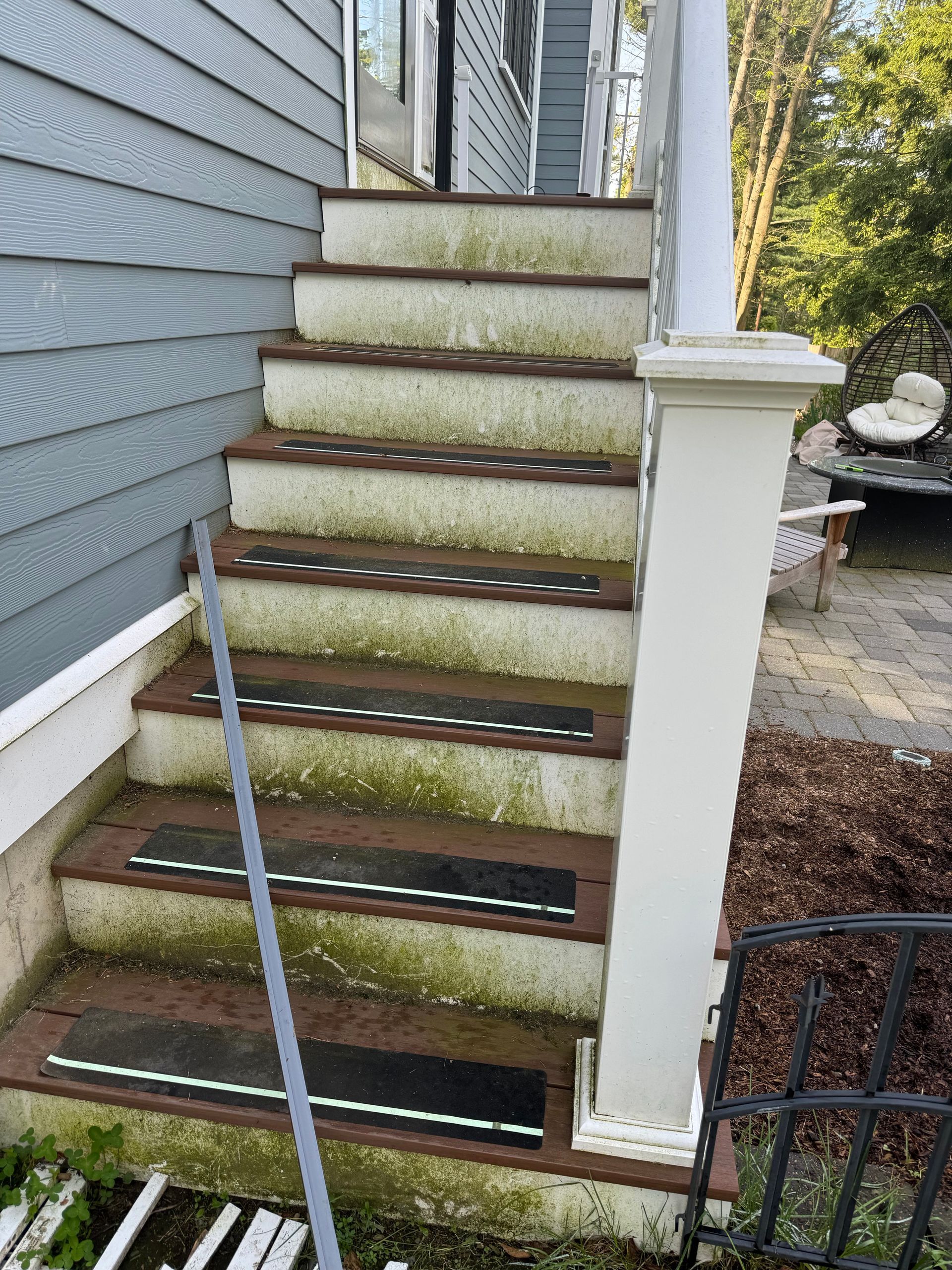 A set of stairs leading up to a porch of a house.