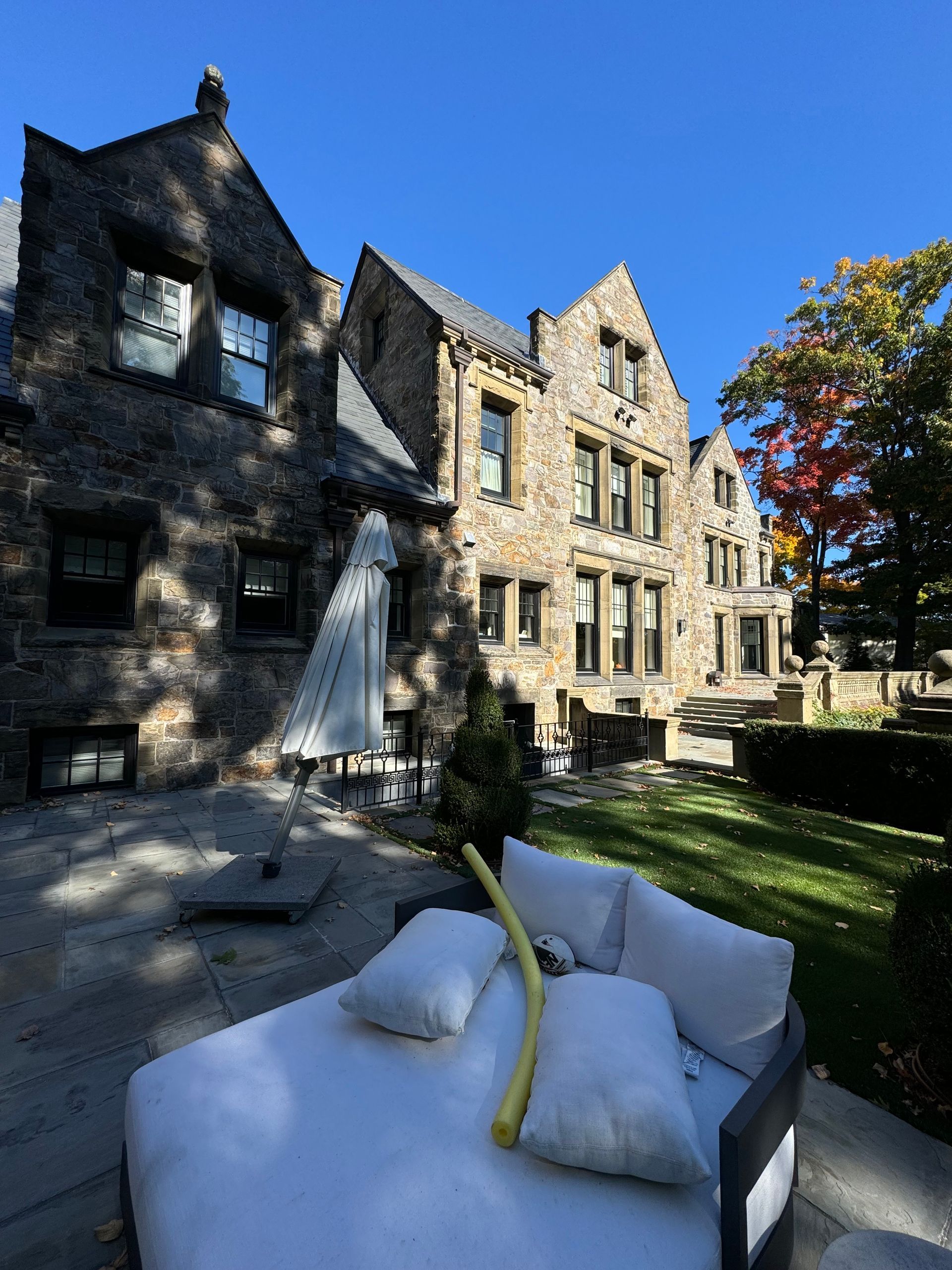 A large stone building with a patio in front of it.