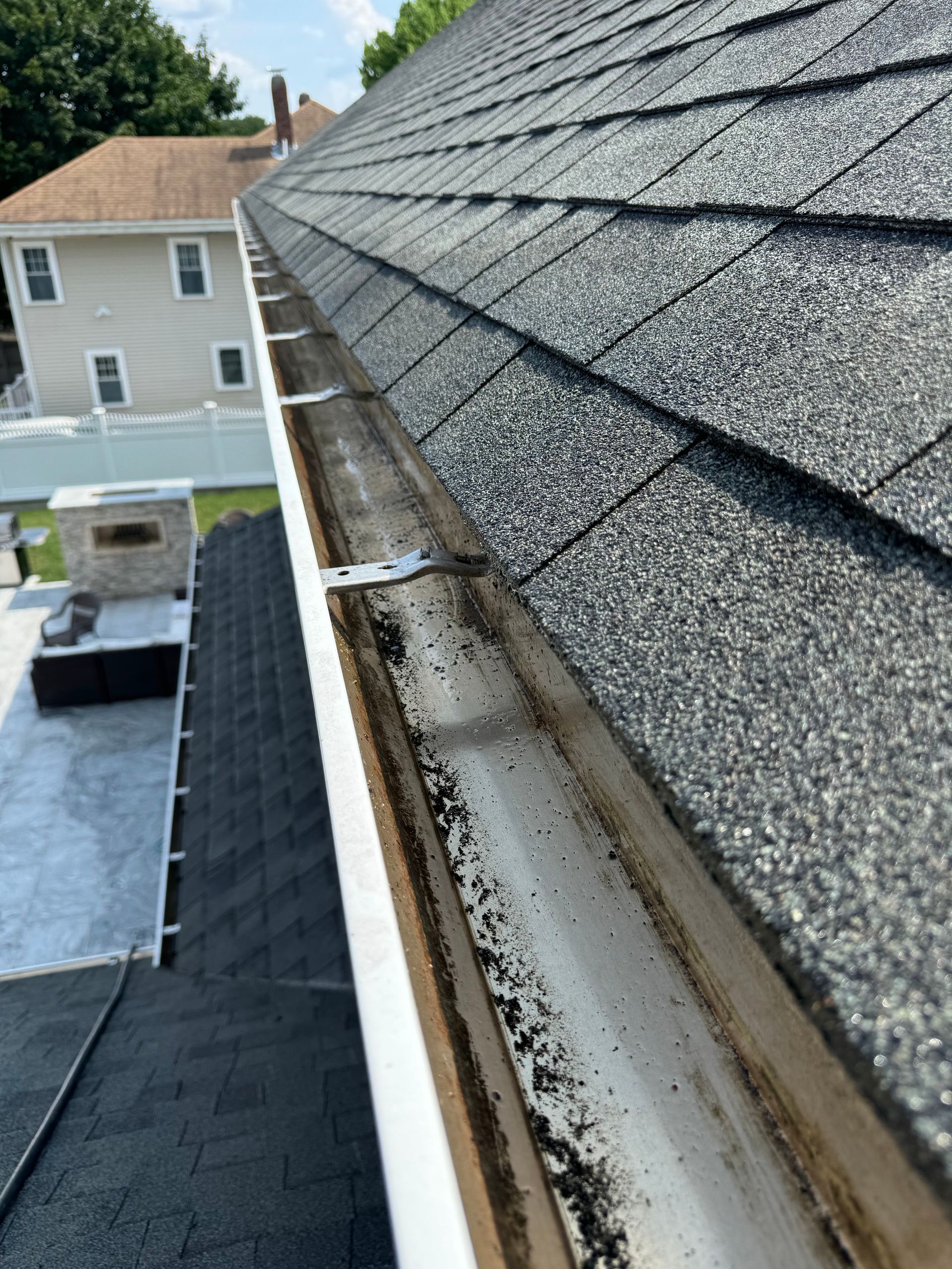 A close up of a gutter on a roof of a house.