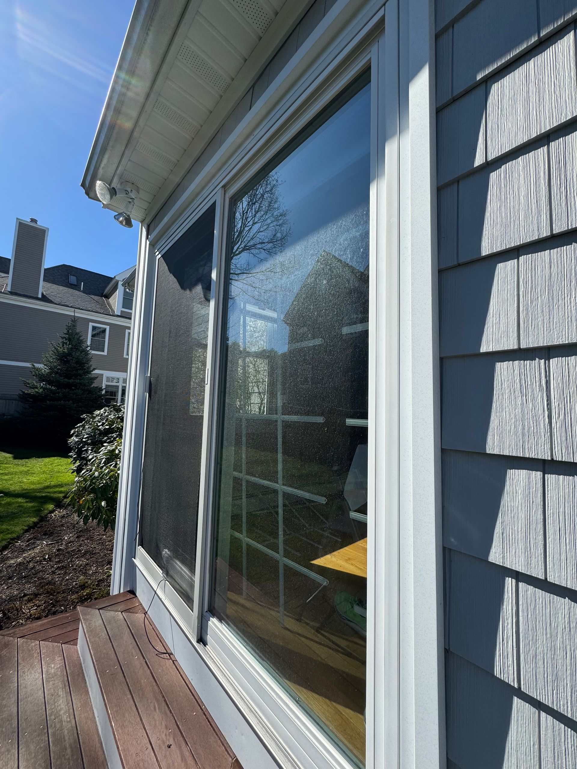 A sliding glass door on the side of a house.