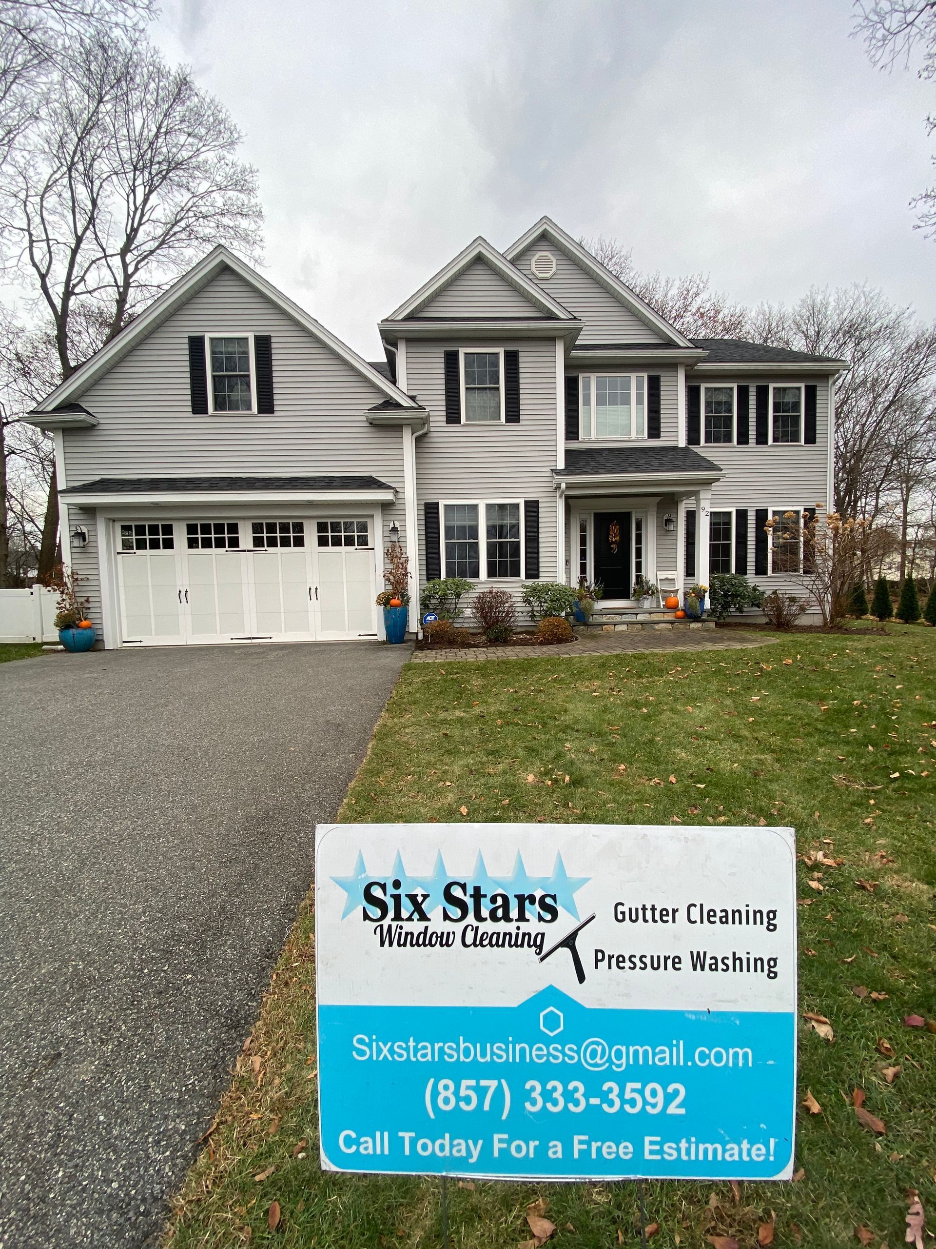 A large house with a six stars sign in front of it.