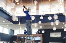 Electrician installing hanging lights
