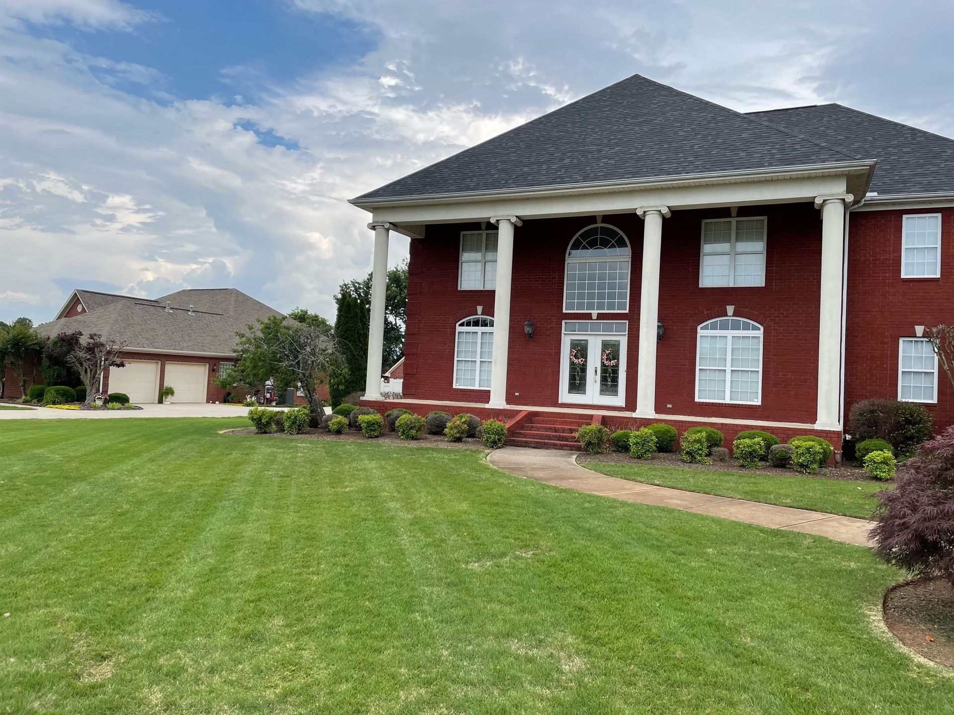 big lawn and red house