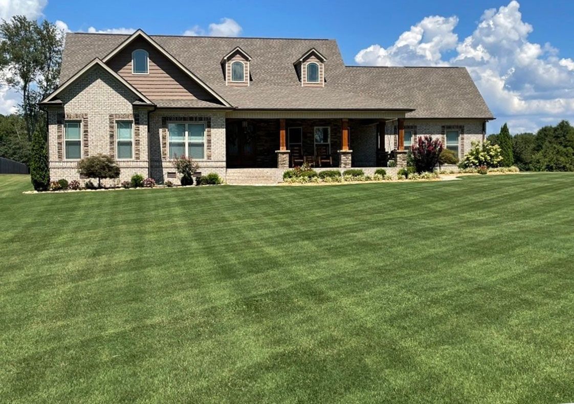 A large house with a lush green lawn in front of it