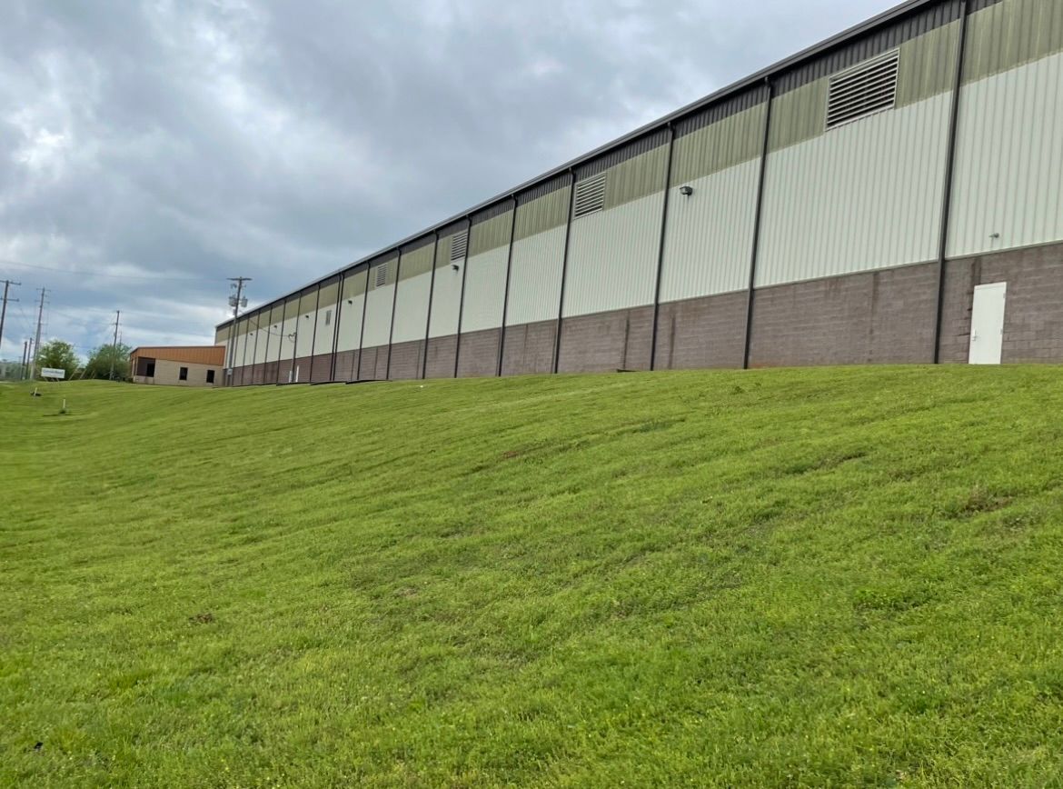 A large building with a lawn in front of it