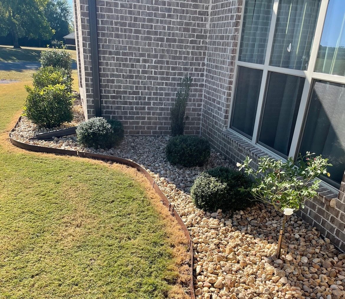 A brick house with a garden in front of it