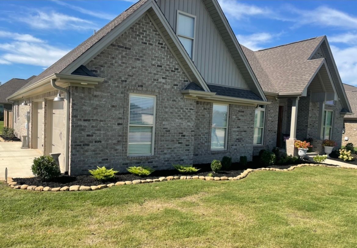 Large brick house with a large lawn in front of it