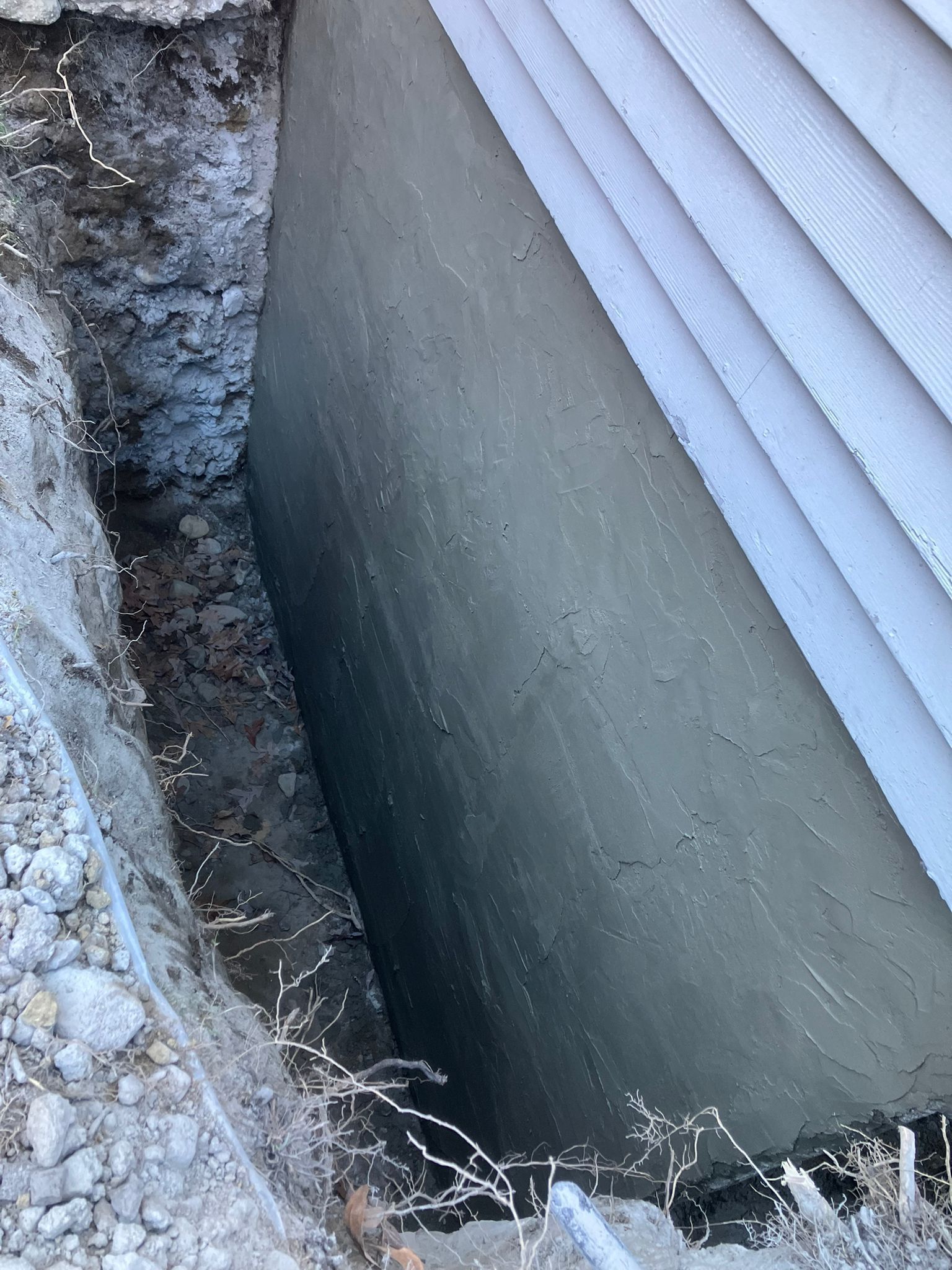 A concrete wall is being built next to a house.
