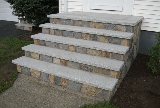 A set of stone steps leading up to a house.