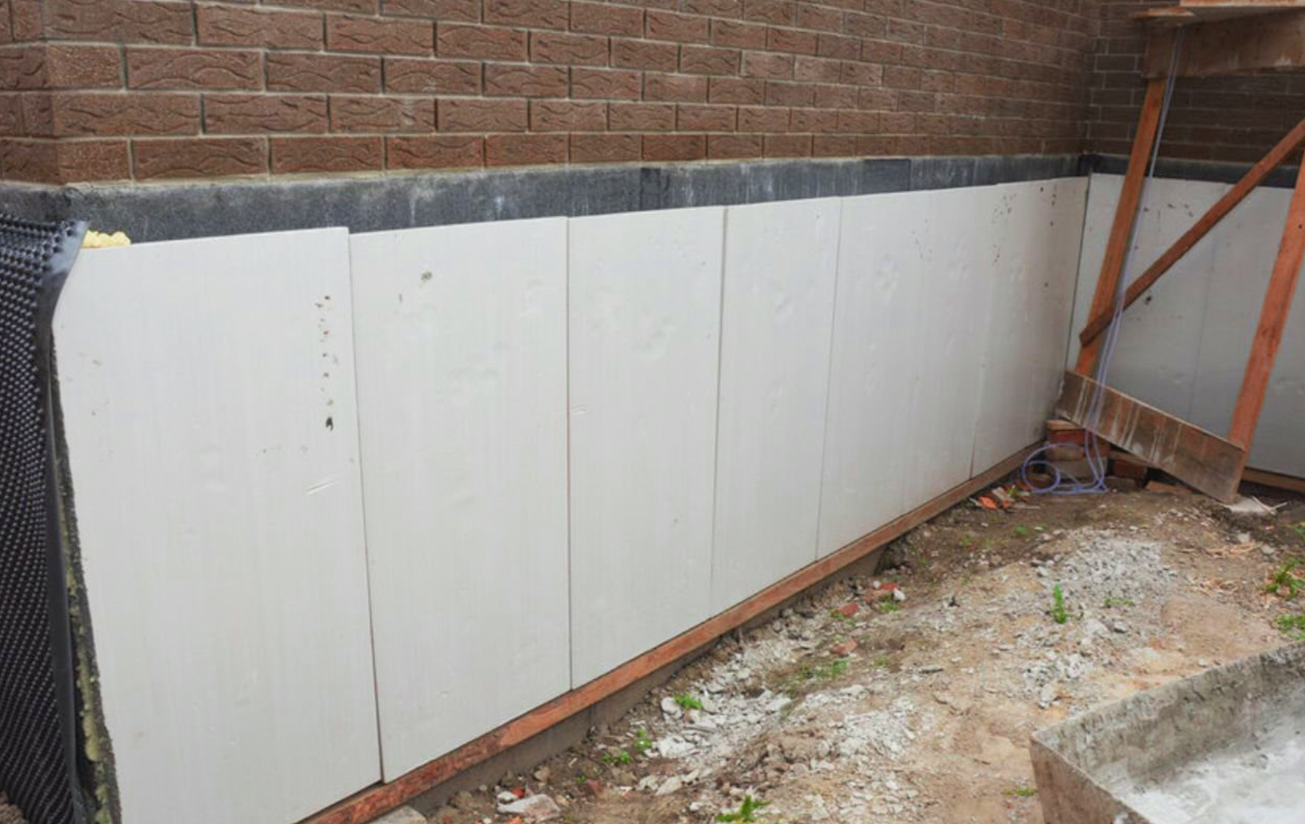 A brick wall with a lot of white boards on it.