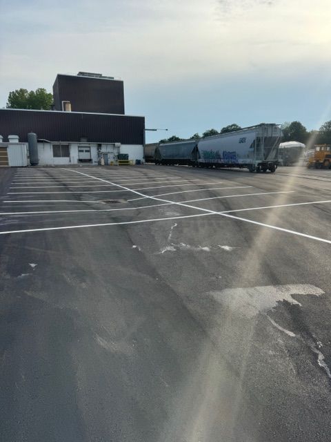 A parking lot with a building in the background