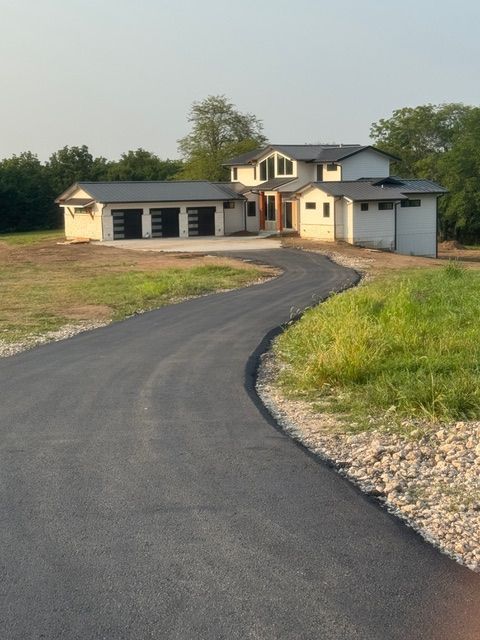 A large house with a curved driveway leading to it
