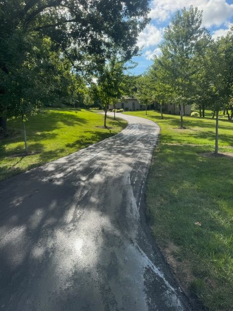 A road that is surrounded by trees and grass