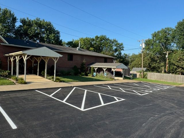 A parking lot in front of a brick building