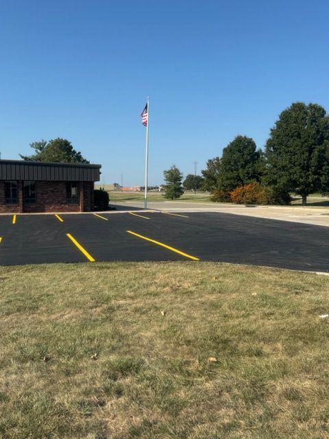 A parking lot with a brick building in the background