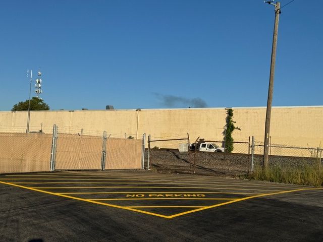 A parking lot with a yellow line that says no parking