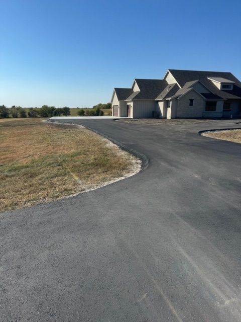 A large house sits on the side of a road