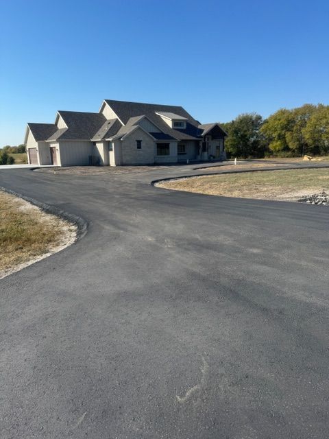 A large house sits on the side of a road