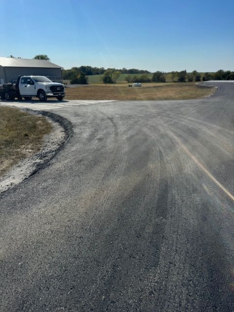 A white truck is parked on the side of the road