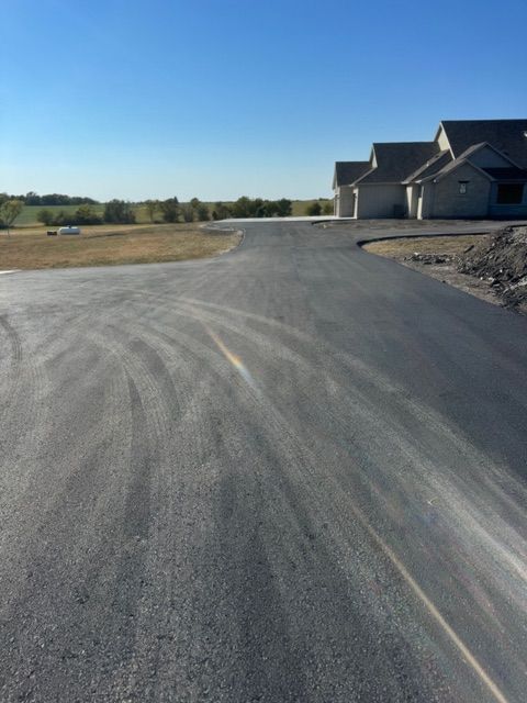 A road with a few houses on the side of it