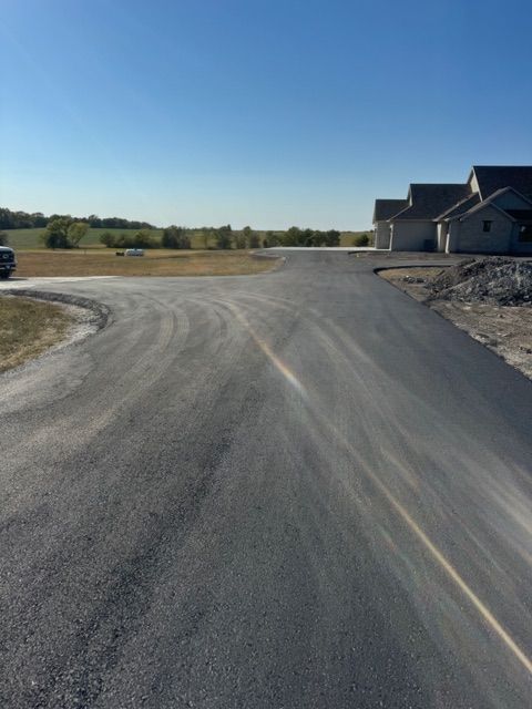 A road with a few houses on the side of it