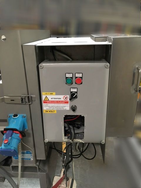 Gray industrial control panel with green and red buttons and exposed wiring inside a metal enclosure