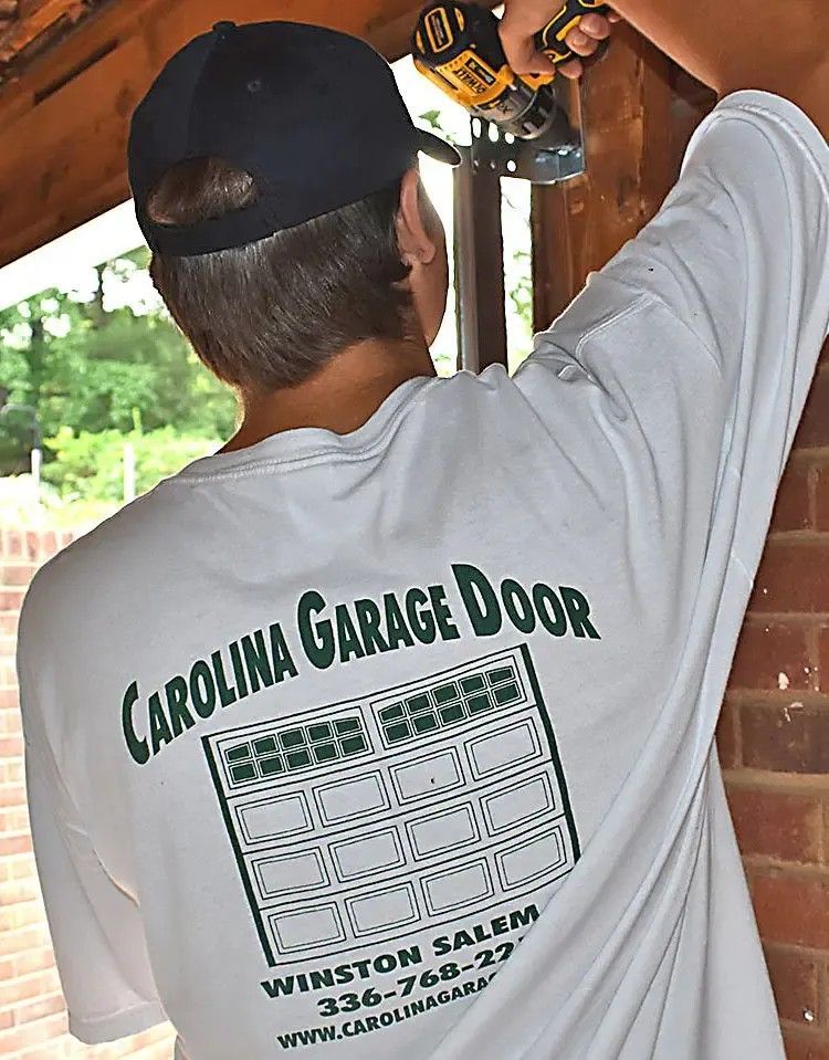 Person installing something, wearing a white shirt with 