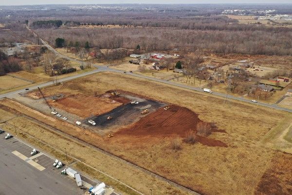 An aerial view of a construction site in the middle of a field.