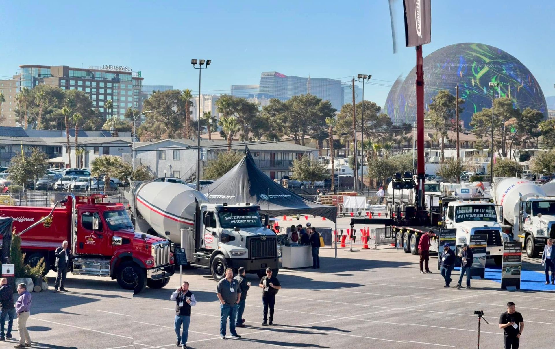 A lot of trucks are parked in a parking lot.