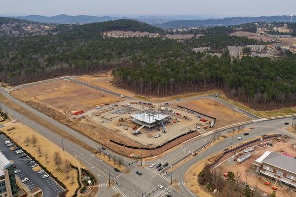 An aerial view of a construction site in the middle of a forest.