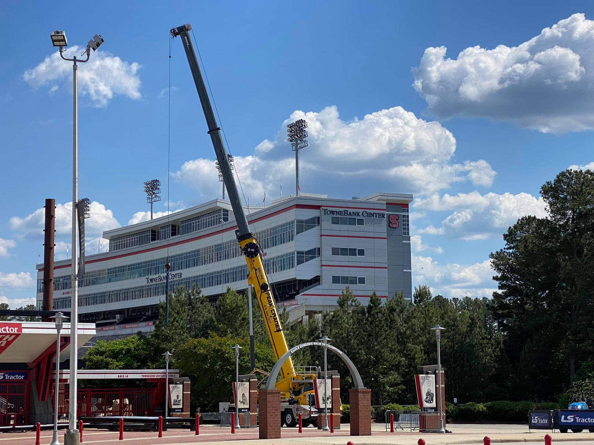 A large crane is sitting in front of a large building.