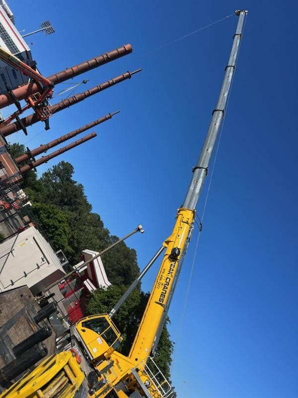 A large yellow crane with a blue sky in the background