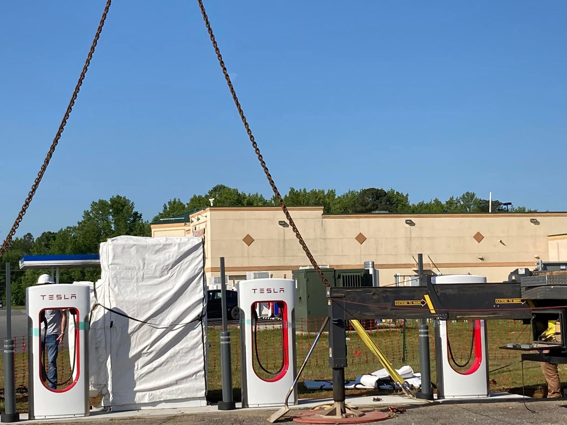 A tesla charging station is being built in a field