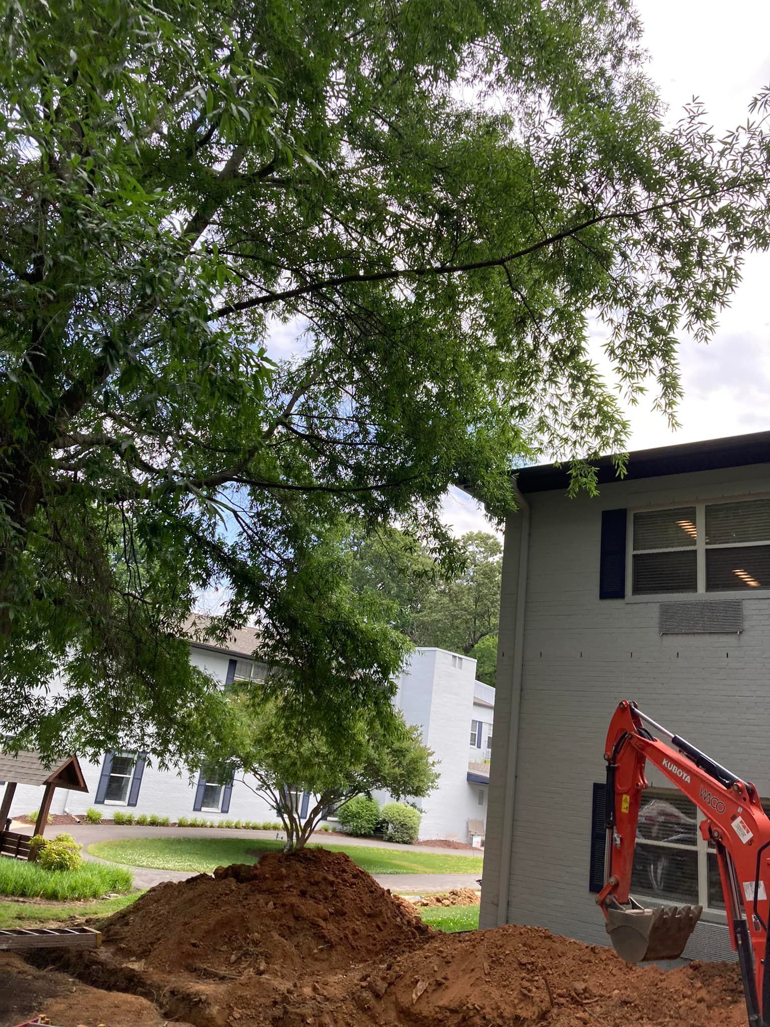 A large pile of dirt is sitting in front of a house.