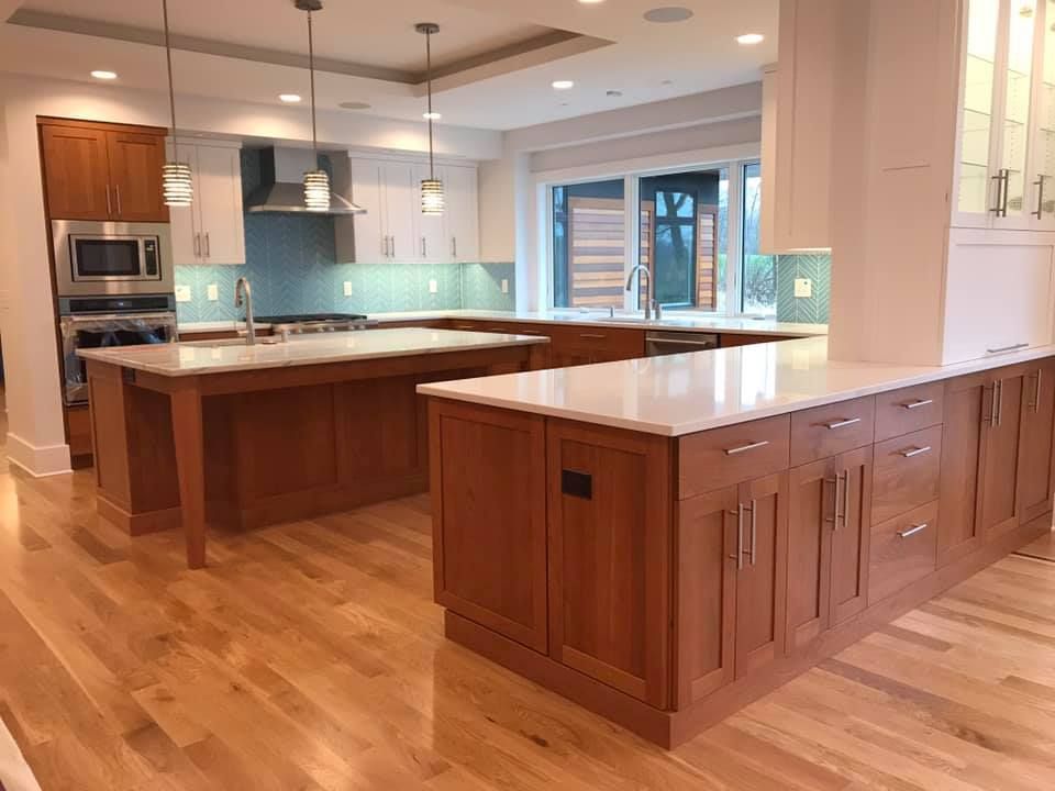 Spacious kitchen with wood cabinets, light countertops, and a large island. Bright, open space.