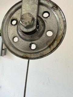 a close up of a metal wheel with holes in it .